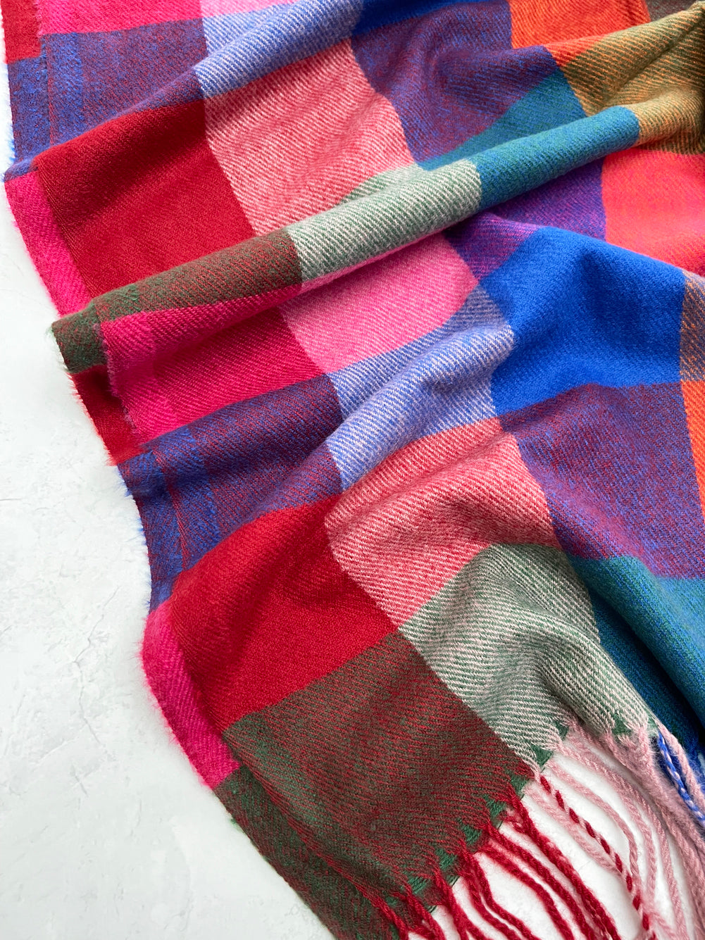 Multi-coloured scarves in vibrant patterns and assorted colours for stylish everyday wear.